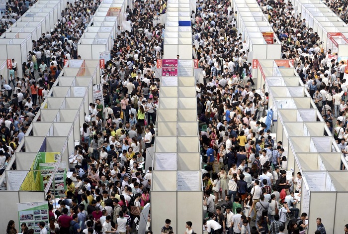Тысячи лиц, ищущих работу, рассматривают стенды на ярмарке вакансий в городе Чунцин.